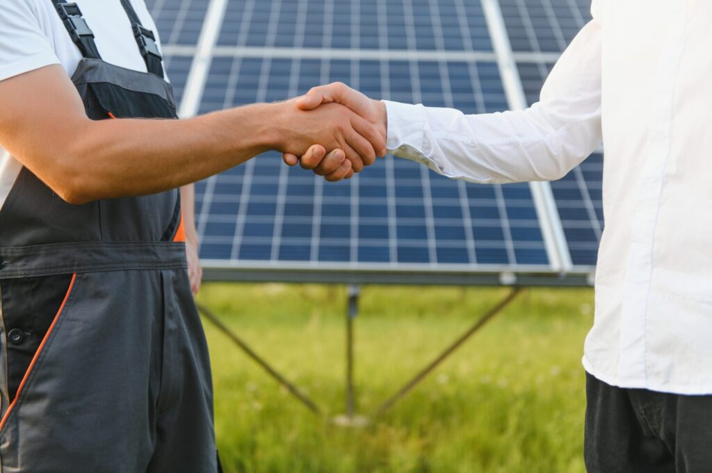 Shaking hands of businessmen and engineers